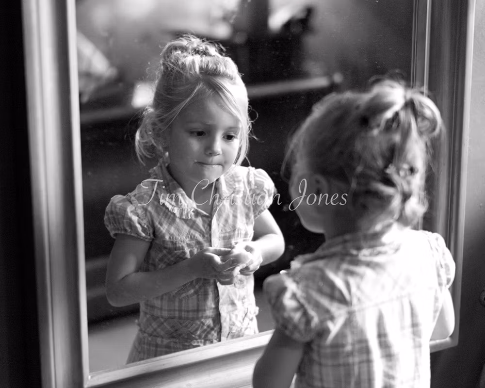 Bride's daughter looking into the mirror