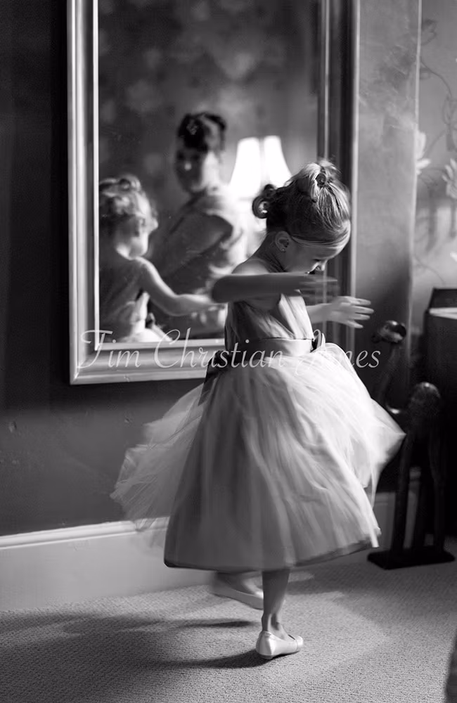 Bridesmaid twirls in the mirror at an April wedding