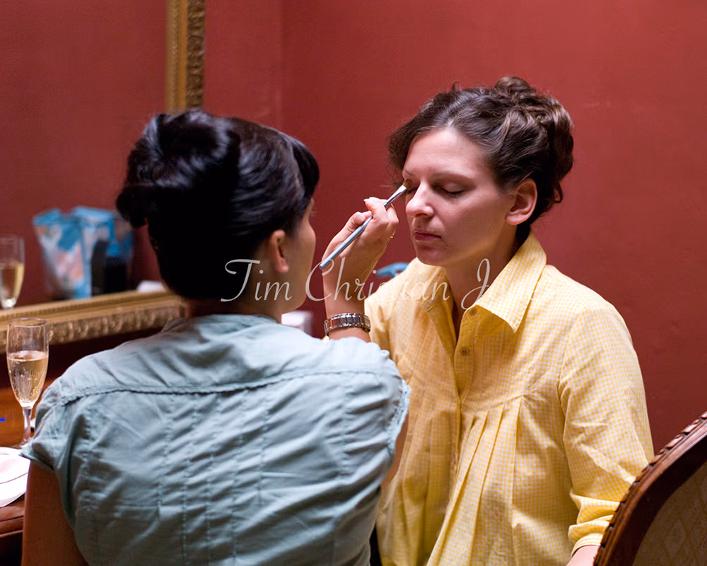 The bride having make up done by her sister