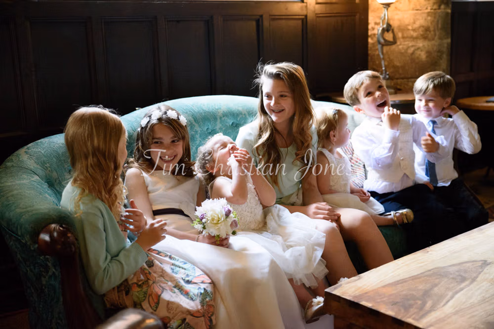 Children chatting on the sofa making a lovely natural wedding group photo that will remain timeless captured at Grays Court Hotel, York
