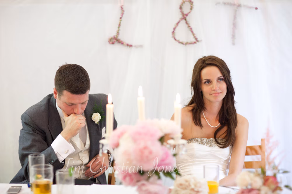 Groom holding back emotion while Lowri remains calm beside him