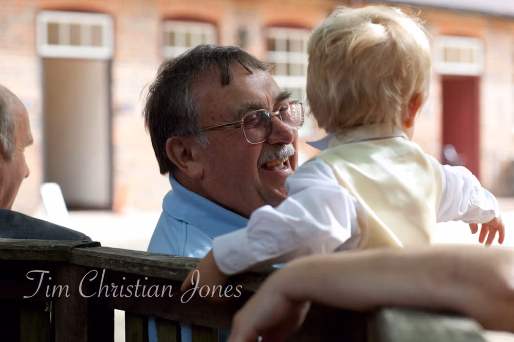 Family members cuddling the groom’s son outside the venue