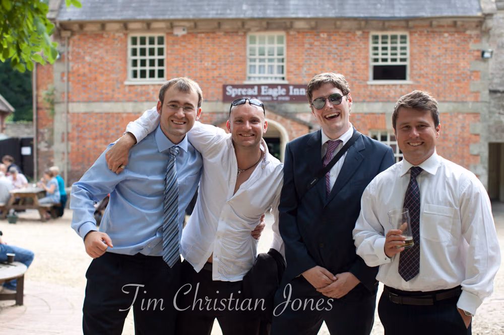 A group of wedding guests gather for an unplanned photo