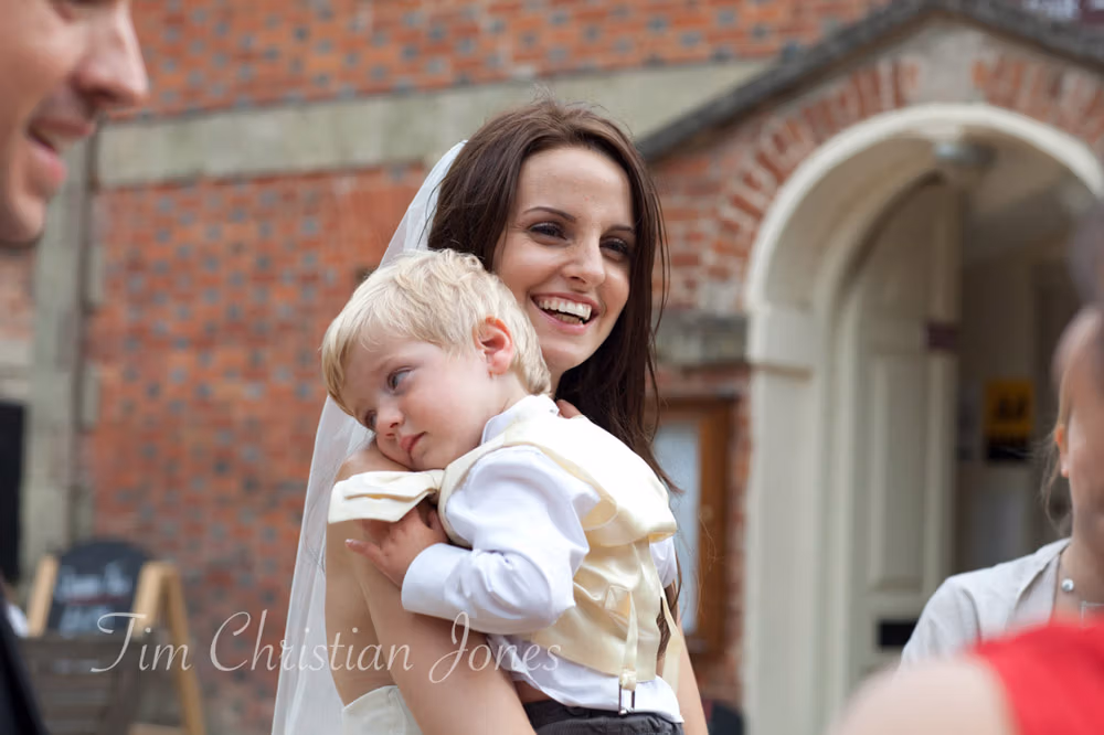 Lowri smiling as she cuddles her young son near the end of the day